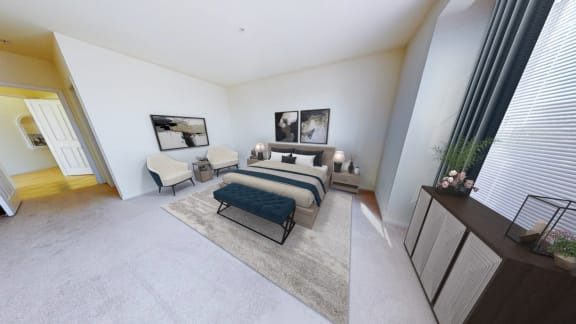 a bedroom with a bed and two chairs in a hotel room