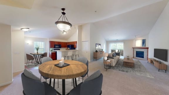 a living room and dining room with a table and chairs