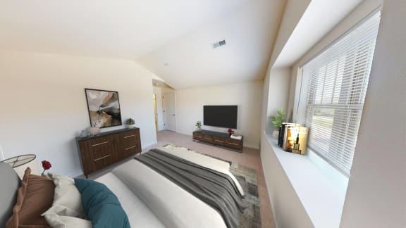 a bedroom with a bed and a tv