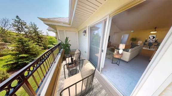 a patio with a table and chairs on a balcony