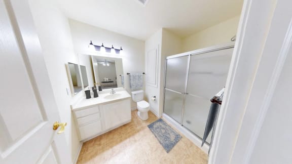 a bathroom with a shower and a sink and a toilet