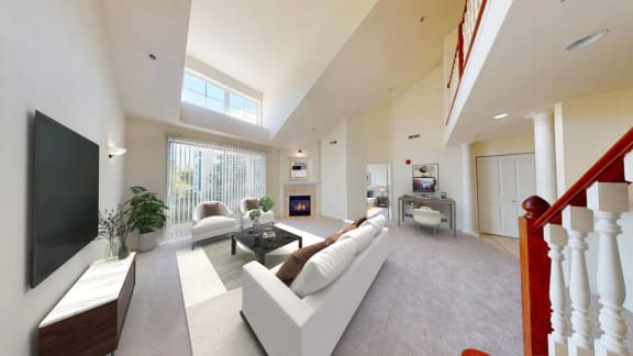 a large living room with a white couch and a television