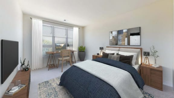 an open bedroom with a bed and a desk with a window