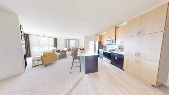 a kitchen and living room with a table and chairs