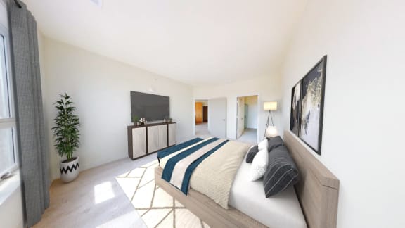 a bedroom with a bed and a tv
