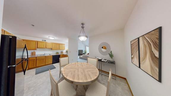a dining room and kitchen with a table and chairs