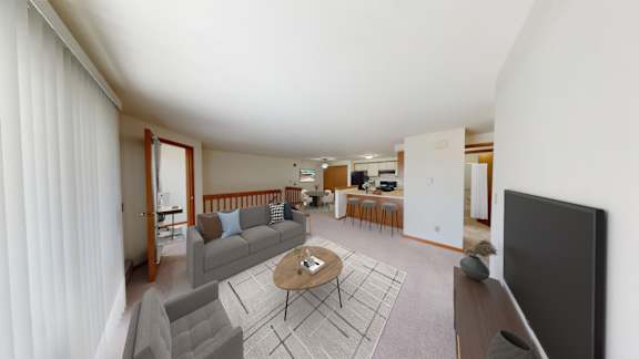 A living room with a grey couch and a coffee table.