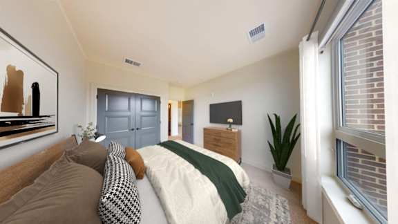 A bedroom with a bed, a dresser, and a painting on the wall.