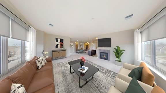 A living room with a brown couch and a grey rug.