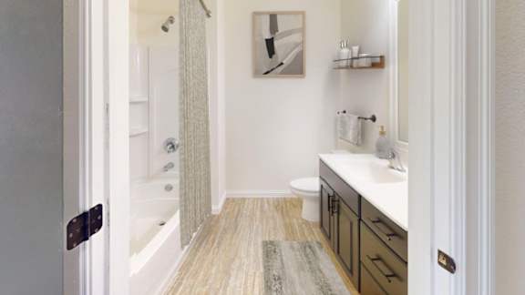 A bathroom with a toilet, sink, and bathtub.