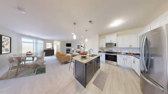 A modern kitchen with a dining table and chairs.