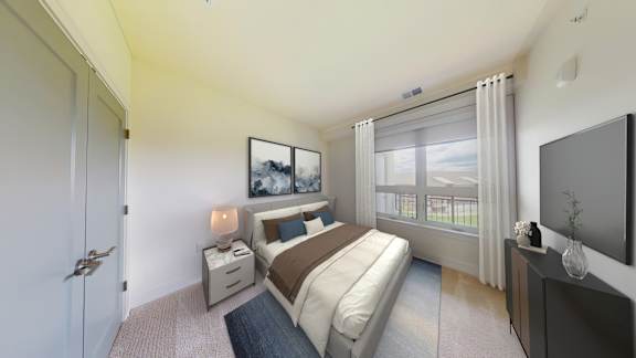A bedroom with a bed, nightstand, and a window with curtains.