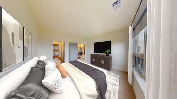 A modern bedroom with a large bed and a flat screen TV.