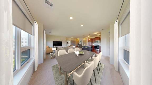 A modern dining room with a large table and chairs.