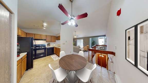 A modern kitchen with a dining table and chairs.