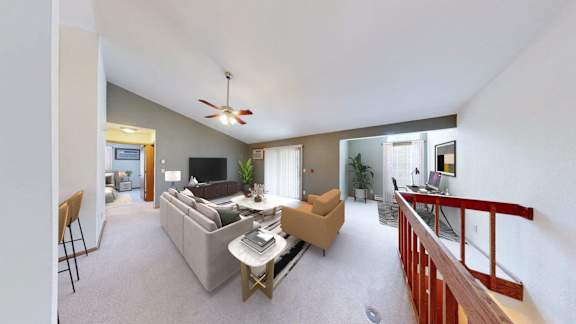 A living room with a couch, chairs, and a television.