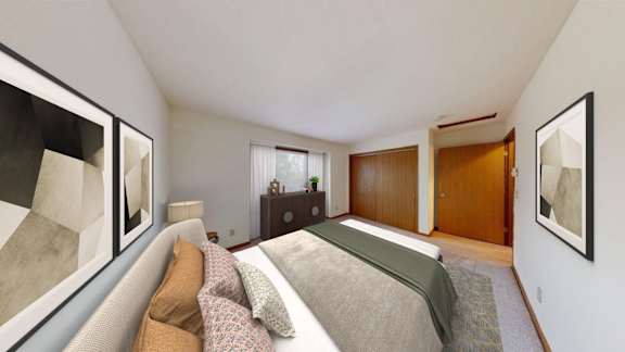 A bedroom with a bed, dresser, and two framed pictures on the wall.