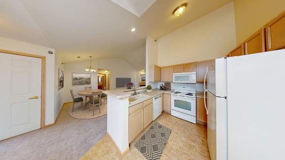 A kitchen with a white fridge and a white oven.