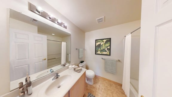 A bathroom with a white sink and a toilet.
