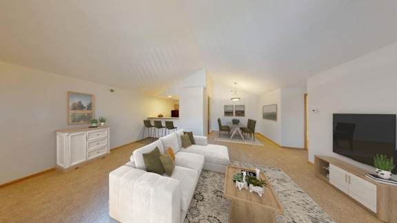 A living room with a white couch and a coffee table.