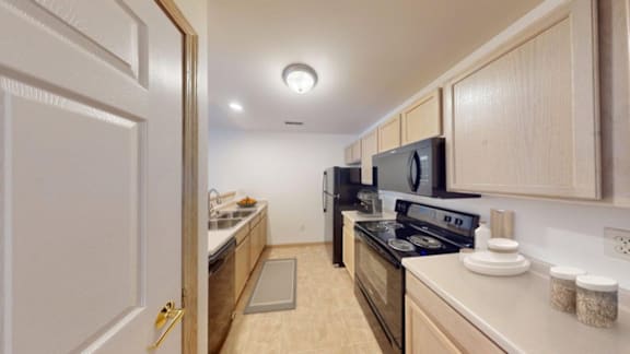 A kitchen with a stove, oven, and microwave.