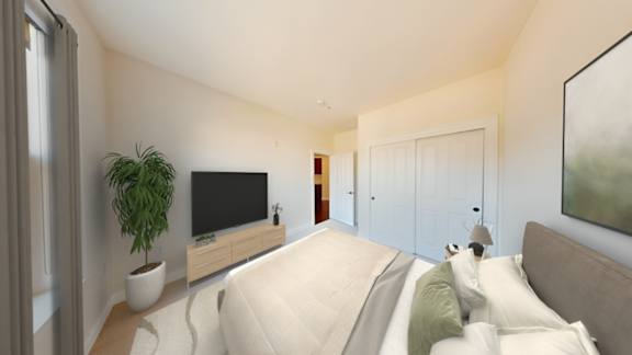 A modern bedroom with a large bed and a flat screen TV.