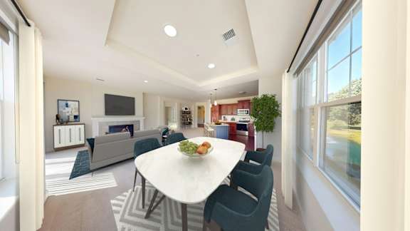 A modern living room with a white table and blue chairs.