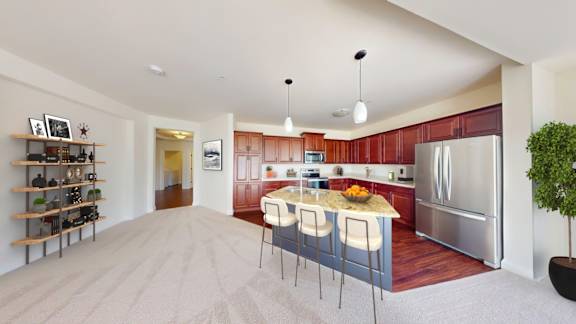 A kitchen with a refrigerator, stove, and sink.