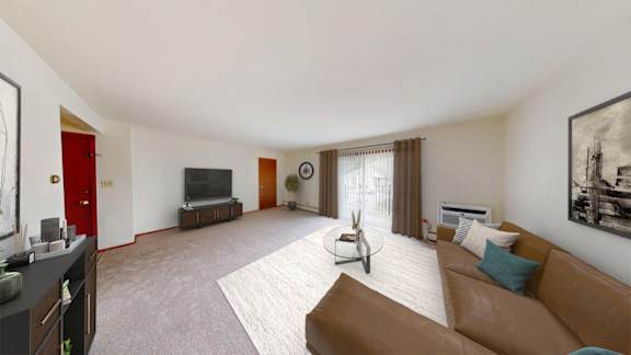 A living room with a brown couch and a television.