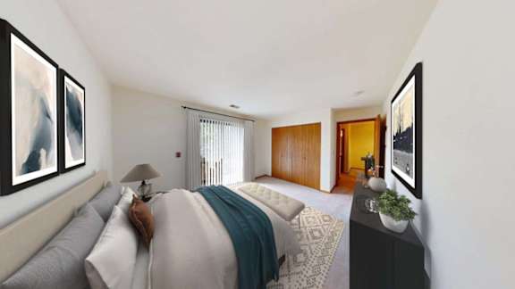 A bedroom with a bed, nightstand, and two framed pictures on the wall.