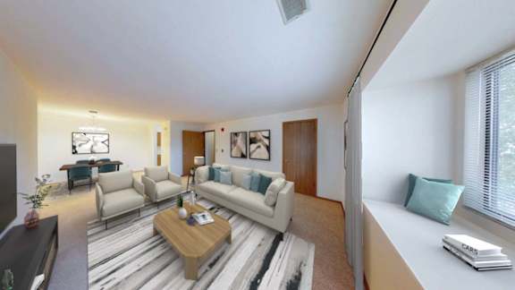 A living room with a white couch and a coffee table.