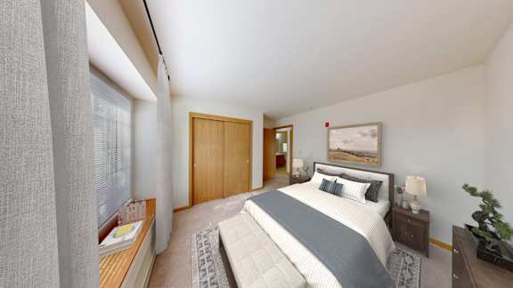 A bedroom with a large bed and a wooden door.