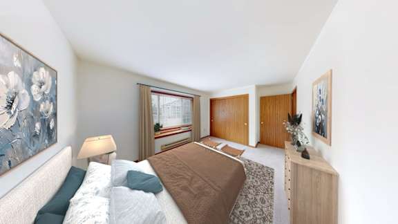 A bedroom with a bed, nightstand, and a painting on the wall.