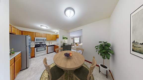 A kitchen with a table and chairs in the middle of the room.
