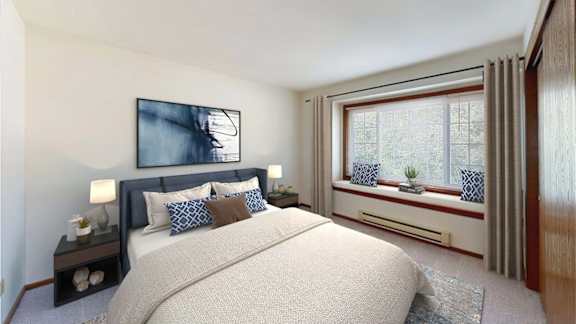 A bedroom with a large bed and a painting on the wall.