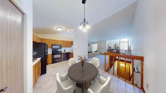 A modern kitchen with a dining table and chairs.