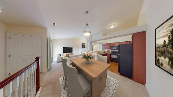 A dining room with a wooden table and chairs.
