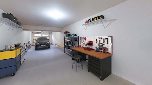 A garage with a workbench and a car in the background.