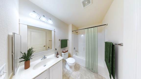 A bathroom with a white sink, toilet, and bathtub.