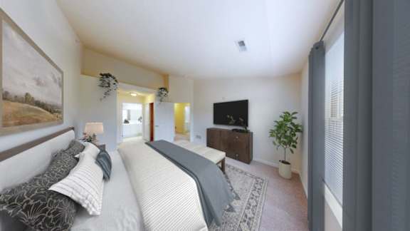 A bedroom with two beds and a television.