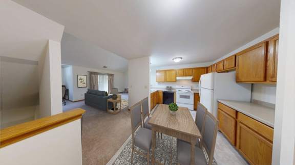 A kitchen with a table and chairs in the middle of the room.