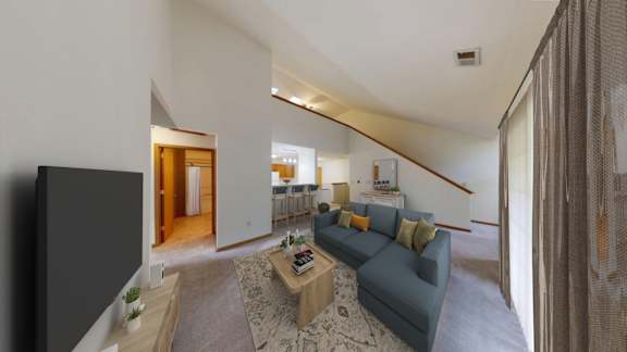 A living room with a grey couch and a wooden coffee table.