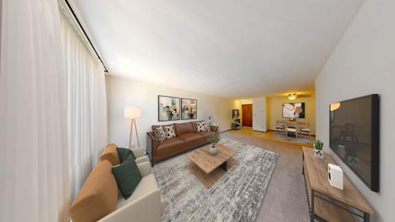 A living room with a couch, a coffee table, and a television.