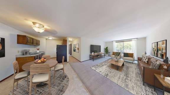 A spacious living room with a dining table and chairs.
