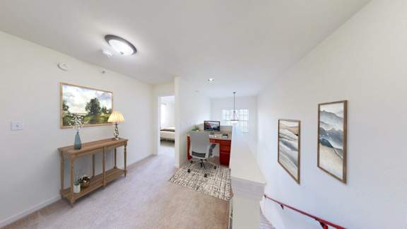 A room with a table, chairs, and pictures on the wall.