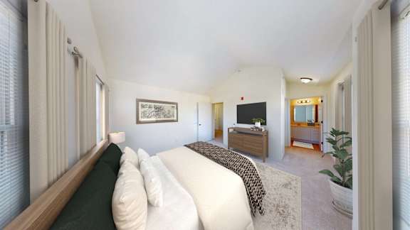 A bedroom with a bed, dresser, and mirror.