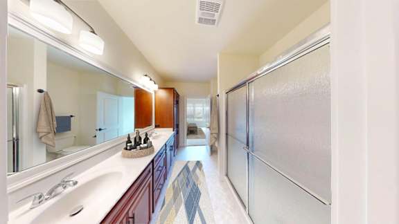 A bathroom with a white sink and a mirror.
