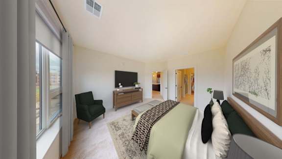A living room with a black chair and a green couch.