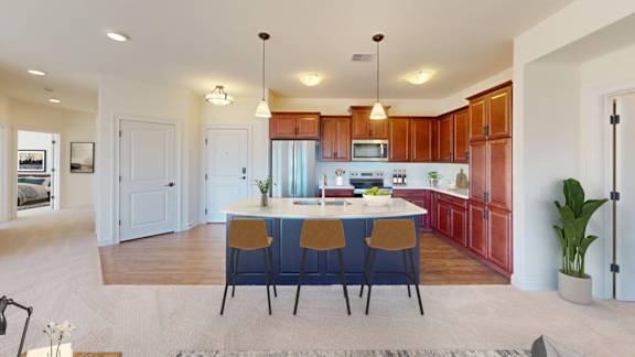A kitchen with a table and chairs in the middle of the room.