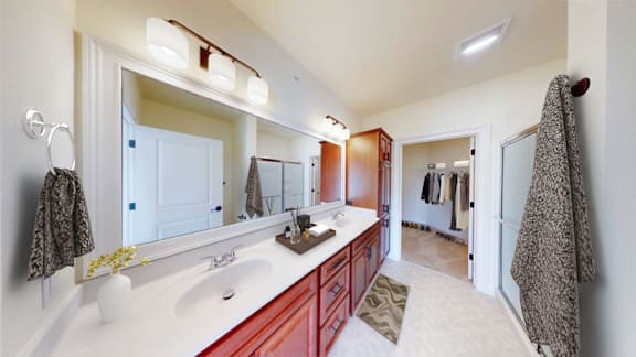 A bathroom with a red vanity and a large mirror.